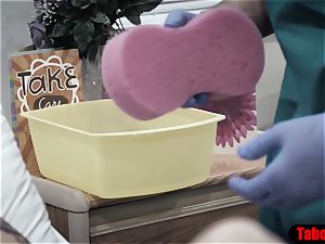 medic gives patient a sponge bath and vaginal probe